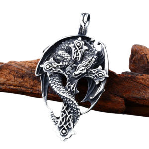 Vintage silver dragon cross pendant necklace polished stainless steel side angle view on wooden background
