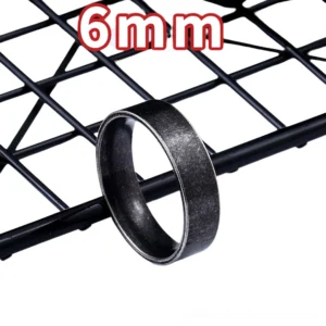 6mm width stainless steel gothic ring featuring distressed matte black texture and vintage metal band, displayed against industrial metal grid backdrop