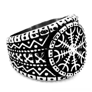 Aegishjalmur Norse protection ring in stainless steel with antiqued silver-black finish, featuring engraved Helm of Awe and tribal rune patterns, shown from left oblique angle