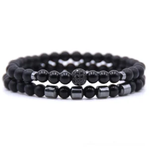 All-black natural stone bead bracelets set with polished black beads, metal cylindrical spacers, and decorative paved charm
