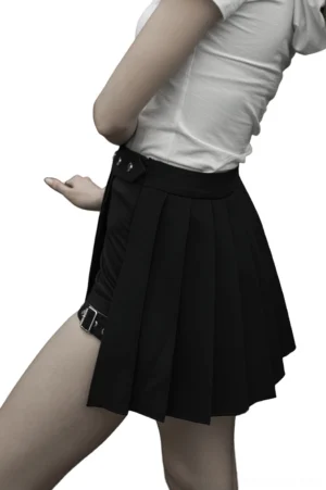 Side profile of asymmetrical gothic pleated mini skirt with side buckle strap on female model