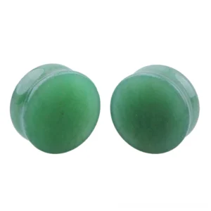 Natural light green aventurine stone ear gauges in multiple sizes, double-flared flesh tunnel design, flat lay product photography