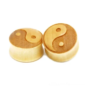 Bamboo wood ear gauges with hand-carved yin-yang symbol in golden yellow, multiple sizes displayed, flat lay front view on white background