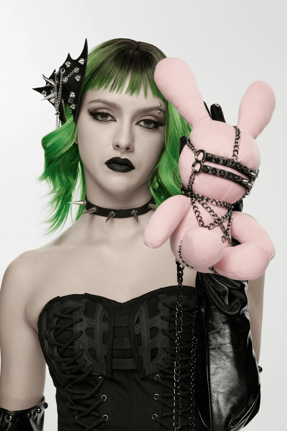 Female model wearing bat wing hair clip with gothic styling, black corset top, and punk aesthetic