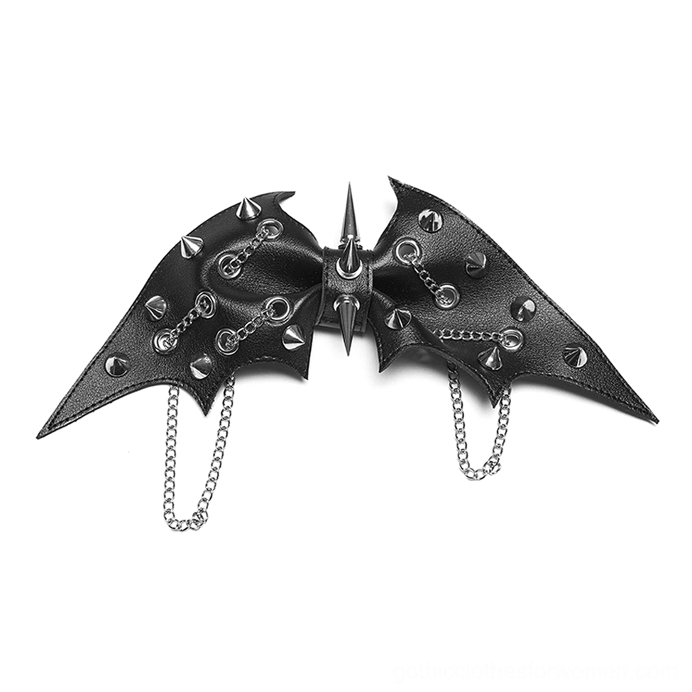 Flat lay showcase of dual black bat wing hair clip with silver metal decor on white background