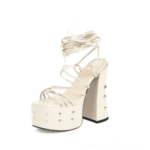 Beige gothic platform lace-up sandals with metal studs and chunky square block heel, alternative fashion sandals front three-quarter view