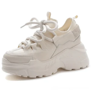 Beige women's chunky platform sneakers with ribbed heel detail and elevated sole, front three-quarter view