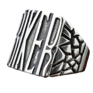 Biker signet ring angled side view showing cracked ornament pattern and vintage silver-black finish