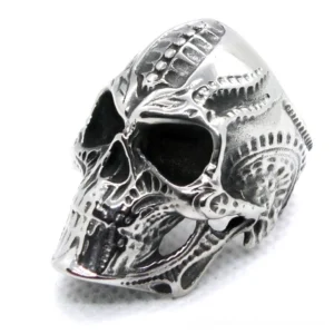 Biomechanical gothic skull ring left three-quarter view showing intricate stainless steel engraved details on white background