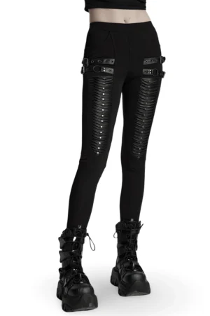 Black 3D pleated gothic leggings with faux leather straps and studs, front three-quarter view on model