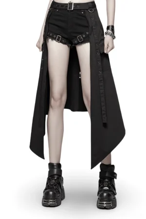 Black asymmetrical cargo mini skirt front view on female model wearing platform boots and denim shorts, showcasing punk gothic alternative fashion style