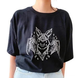 Black bat graphic gothic t-shirt worn by woman with light blue jeans, front view showing white bat print design