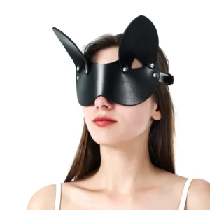 Black synthetic leather bunny ear mask with metal rivets, front view on model showcasing rabbit ear silhouette