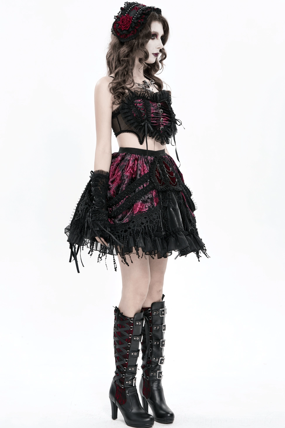 Studio photograph of black mesh gothic bustier highlighting burgundy velvet panels and ornate ribbon lace-up construction detail