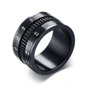 Black camera lens spinner ring stainless steel with engraved aperture markings, 45-degree side view gothic jewelry