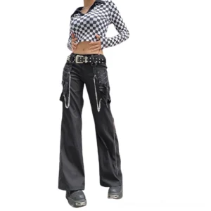 Black gothic cargo pants with chain embellishments, worn by female model in white studio, front full-body view showcasing wide-leg silhouette and metal hardware details