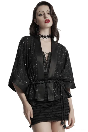 Black gothic kimono cape with starry constellation print, front three-quarter view on model, showing wide batwing sleeves and adjustable braided waist tie