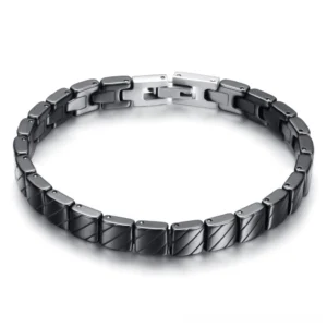 Black ceramic link bracelet with textured finish and silver toggle clasp, overhead flat lay view