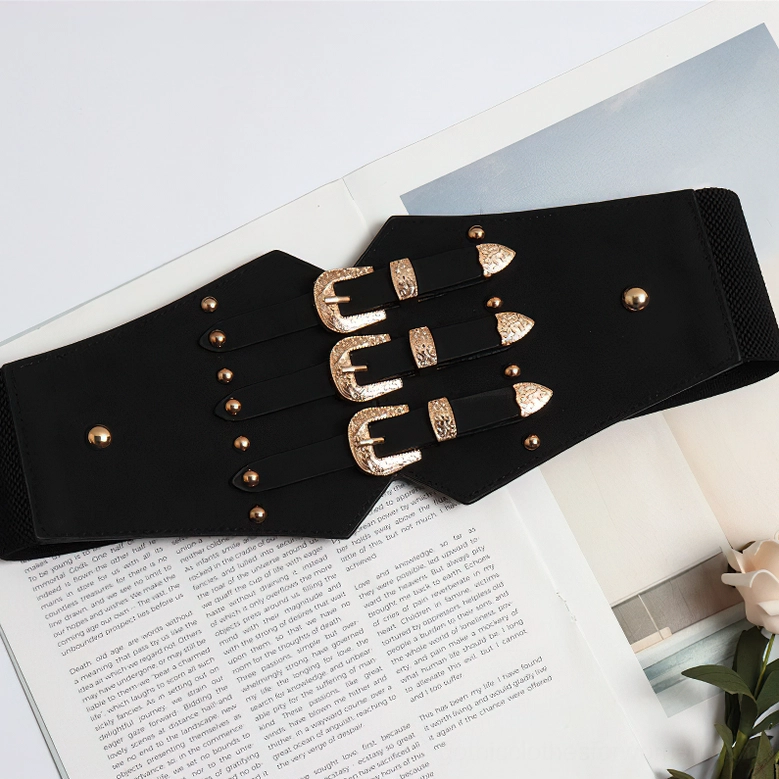 Black wide corset belt side view showing elastic back panel, triple gold buckles, and rivet accents on fabric