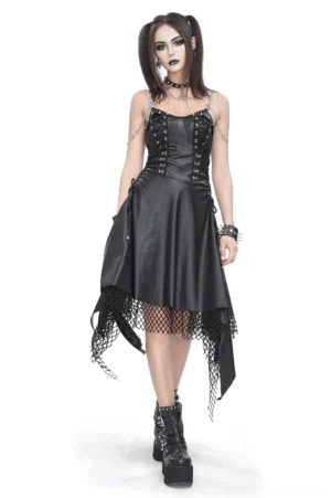 Front view of black lace-up corset dress with asymmetrical fishnet hem worn by goth model with twin ponytails, showcasing the faux leather bust, metal eyelets, and heart chain straps