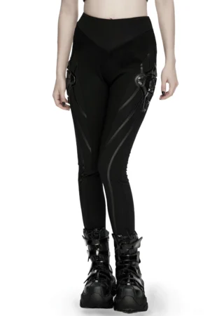 Black cyberpunk armor leggings with 3D side panels worn on female model, front three-quarter view showing segmented seaming and sculptural hip armor elements