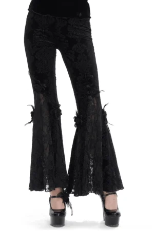 Black damask lace flared gothic pants front view with rose and feather trim details, worn by model on white studio background