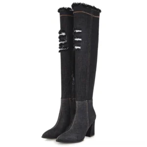 Black denim over-the-knee stiletto boots with frayed collar and distressed ripped details, front three-quarter view