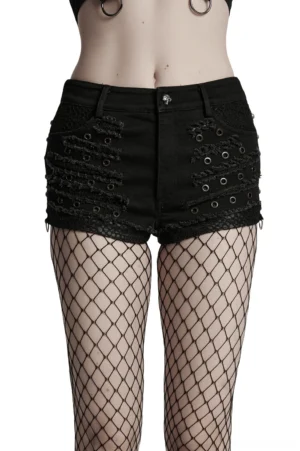 Black distressed gothic denim shorts front view worn with fishnet stockings on female model, showcasing metal eyelets and ripped texture details