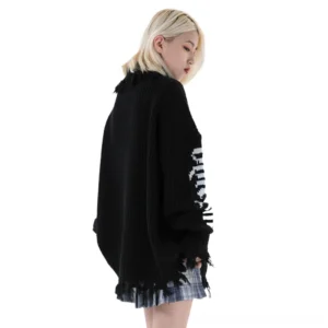 Black distressed oversized turtleneck sweater back view on model - frayed hem and cuff details