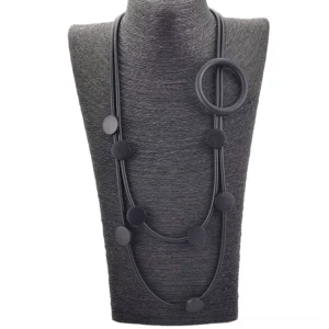 Black double-strand gothic rubber necklace with round ring pendant on mannequin display