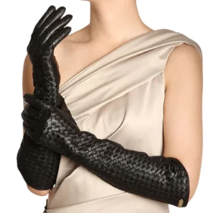 Black elbow-length sheepskin leather gloves with hand-woven texture worn by model, demonstrating full arm coverage and gothic elegance