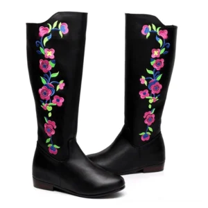 Pair of black mid-calf gothic boots with intricate colorful flower and vine embroidery, front-facing view with low flat heel