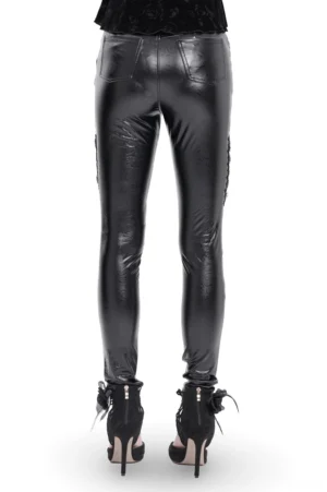Black faux leather gothic pants rear view showing decorative leg panels and back pocket design on model