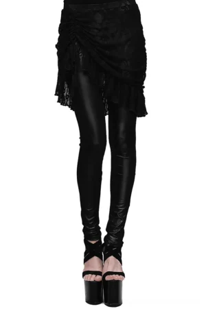 Black faux leather leggings with adjustable ruffled lace skirt overlay, front view on female model