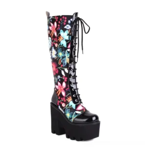 Black floral print lace-up gothic platform knee-high boots with patent leather toe cap and chunky sole, front view