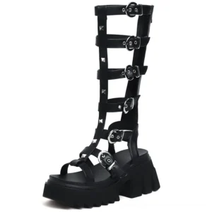 Black patent leather gladiator sandals featuring peep toe design, chunky lug platform sole, and silver D-ring hardware, front right view