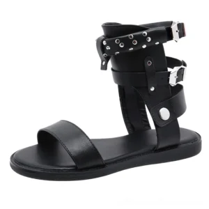 Single black gladiator sandal side view showing ankle strap buckle and silver rivets