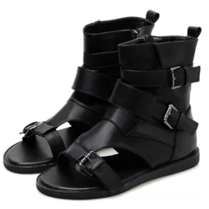 Black gladiator ankle sandals with adjustable buckle straps and open toe design, front three-quarter view showing gothic warrior style