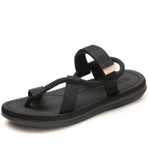 Black unisex gladiator flip flop sandals with woven ankle strap, three-quarter view showcasing minimalist gothic design