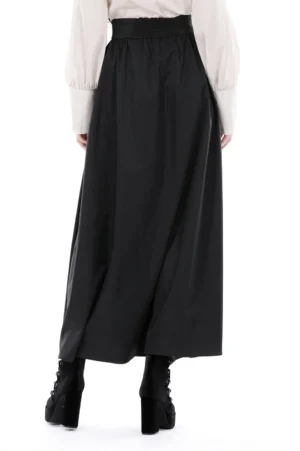 Black gothic skirt back view showing smocked waist design and full floor-length flowing hem on model