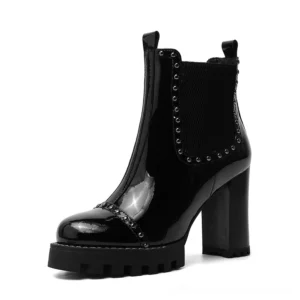 Single black studded ankle boot side three-quarter angle, metal stud collar trim, elastic pull tab detail