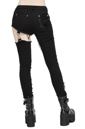 Black gothic skinny trousers with asymmetrical ripped design and metal chains, rear full-body view on model