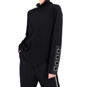 Black gothic asymmetrical top with metal grommet cuff details, full-length sleeves, three-quarter right side view worn by model