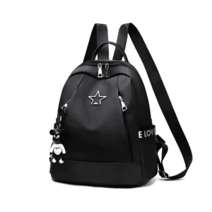 Black gothic vegan leather backpack with metal star badge, bear charm pendant, and embossed letter prints shown in front three-quarter view