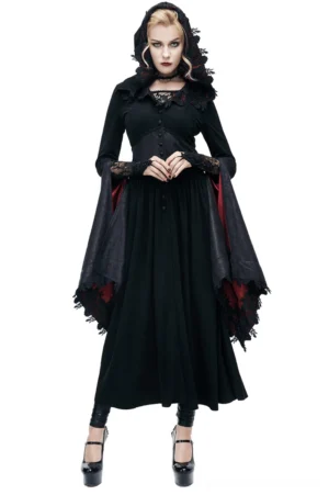 Black gothic batwing coat with crimson hood lining worn by fashion model, front view with dramatic flared sleeves and lace trim detailing