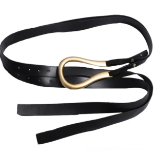 Black leather gothic belt flat lay overhead view, gold buckle and punched adjustment holes clearly visible, professional product photography