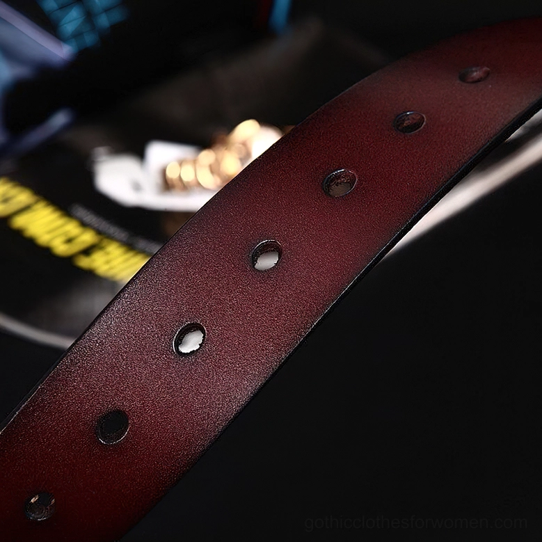 Black leather gothic belt with substantial metal hardware, detailed view of pin fastening system and rivet reinforcement