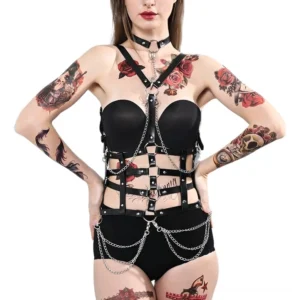 Black gothic body chain harness front view with metal chains and studded leather straps on tattooed model