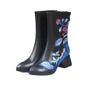Pair of black gothic ankle boots with ethnic embroidery, front three-quarter view, showing side zipper and square block heel without fur lining