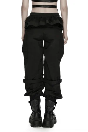 Black gothic cargo pants back view worn by model showing exposed midriff mesh ruffle waist design